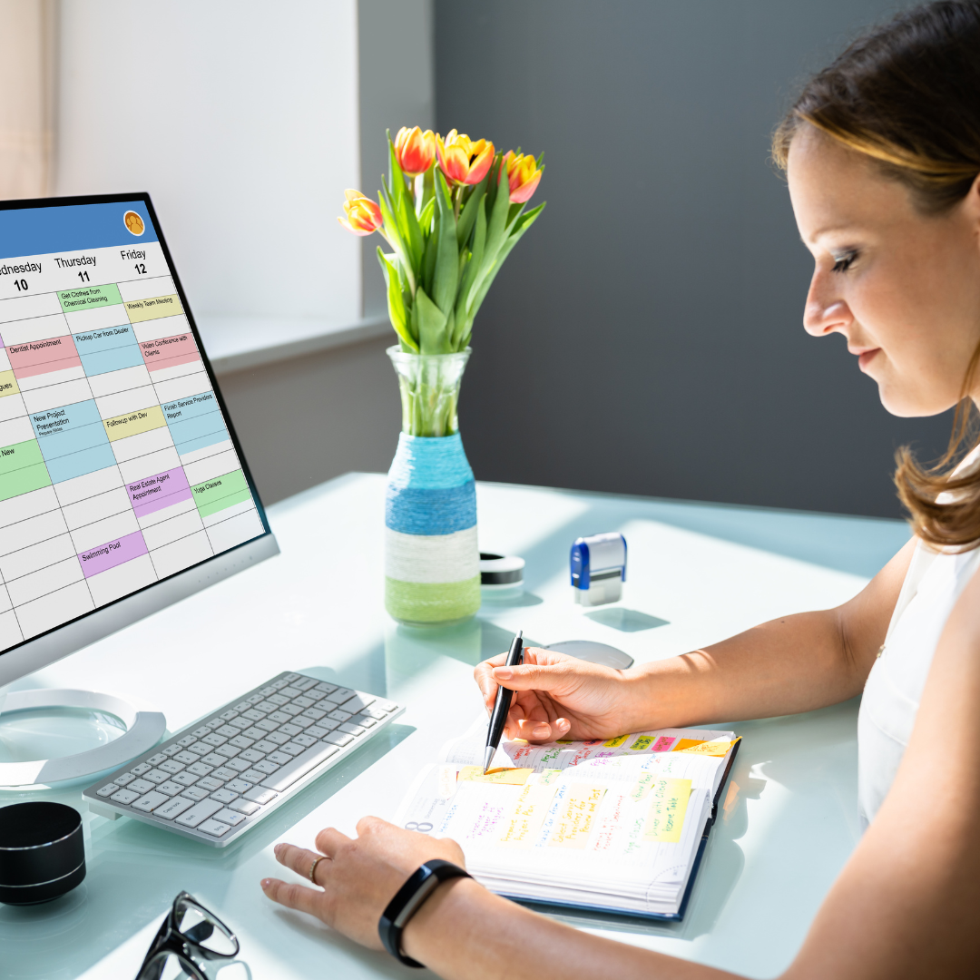 Tech tools on a desk with a laptop, calendar, and smartphone.